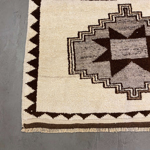 Edge of Aksaray Vintage Wool Rug on a gray floor - H+E Goods Company