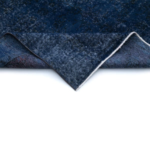 Close-up view of the folded edge of Besni Vintage Distressed Rug - H + E Goods Company