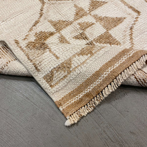 Folded edge of Tasia Wool Runner on gray floor - H+E Goods Company